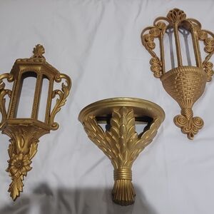 Gold Display Shelves with Ornate Wall Decor